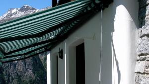 a door to a building with a mountain in the background at Chalet Goldblick in Grächen