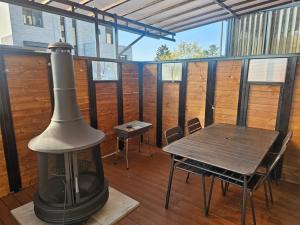 a grill on a screened porch with a table and chairs at Paju Byeol-bom in Paju