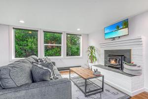 a living room with a couch and a fireplace at Tidal House #6 - Ocean Shores Chalet in Ocean Shores