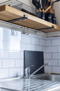 a kitchen sink with a faucet and a counter top at Anderson Apartment in Airdrie