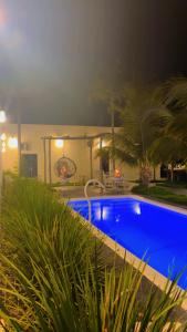 a house with a swimming pool at night at A Casa Piscina Quente até 50 Graus em Caldas Novas Com Sistema de Trocador de Calor e com Sauna e Ofurô Super Quente, Paradisiaca ll Com Roupa de Cama e Banho, Parcelamos em até 12x no Cartão de Crédito Sem Juros Aceitamos Pet in Caldas Novas +19 photos
