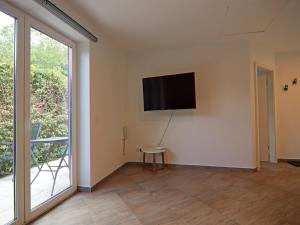 a living room with a flat screen tv on a wall at Doppelhaushälfte Seestern, Lohmen in Lohmen