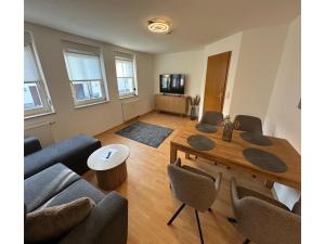 a living room with a wooden table and chairs at behagliche Ferienwohnung in Elstra in Elstra