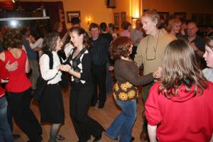 a group of people dancing on a dance floor at Feirm Cottage in Kenmare