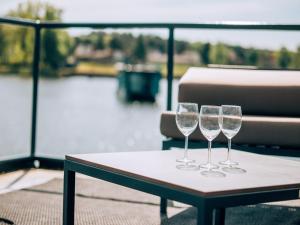 three wine glasses sitting on a table on a boat at behagliches Floating Home in Berlin in Berlin