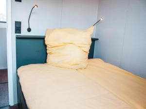 a bed with a pillow on top of it at behagliches Floating Home in Berlin in Berlin