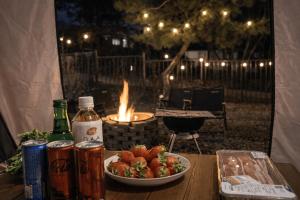 a table with a bowl of strawberries and a plate of drinks at Sejong Hygge Stay in Sejong