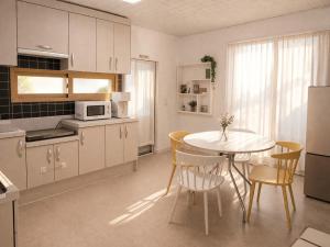 a kitchen with a table and chairs in a kitchen at Sejong Hygge Stay in Sejong