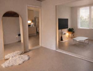 a living room with a large mirror and a table at Sejong Hygge Stay in Sejong +6 photos
