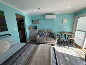 a bedroom with a bed and a table and chairs at Oceanview Loft York in York