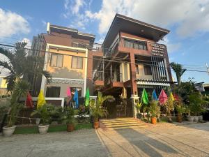 a building with colorful umbrellas in front of it at Southsea Staycation-couple in Nasugbu