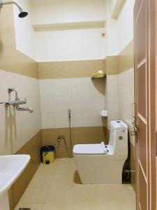a bathroom with a toilet and a sink at Namaste Guest House in Pokhara +37 photos