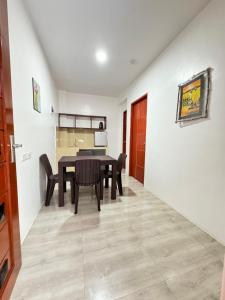 a kitchen and dining room with a table and chairs at Southsea Staycation-couple in Nasugbu