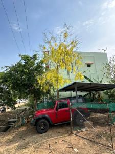 a red truck parked in front of a building at The ARCS in Madurai
