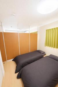 En eller flere senge i et værelse på Guesthouseとき2