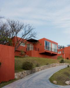 a house on top of a hill with a road at Casa Maja Villas Chapala in Chapala