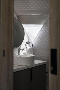 a bathroom with a sink and a mirror at NaturHotel in Cuenca