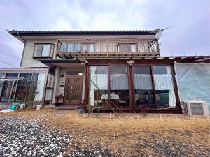 a house with large glass windows on the side of it at ゲストハウス ソウル in Azumino
