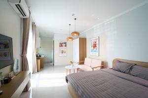 a bedroom with a bed and a table in it at Hanique Cafe and Stay in Hanoi