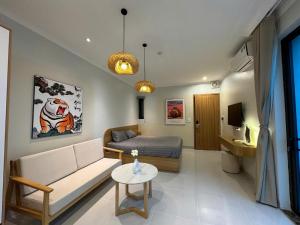 a living room with a couch and a bed at Hanique Cafe and Stay in Hanoi