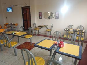 a group of tables and chairs in a room at Hotel Allegria in Quito
