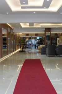 a red carpet in a lobby with a red rug at GoldHome Apart Otel in Famagusta