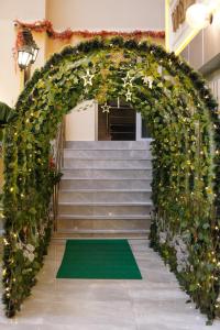 an entrance to a stairway with an arch covered in flowers at GoldHome Apart Otel in Famagusta