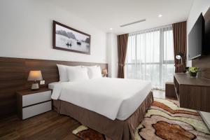 a hotel room with a large bed and a television at Nesta Hotel & Spa in Hanoi +84 photos