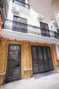 a building with two doors and a balcony at Green West Lake Residence in Hanoi