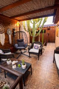 a patio with a table and chairs and a cactus at Hostal Cactus Copiapo in Copiapó +37 photos