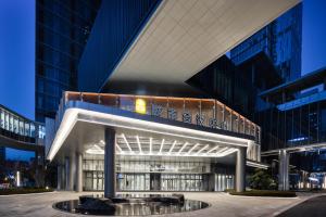 a large building with a lit up facade at night at Pan Pacific Ningbo in Ningbo
