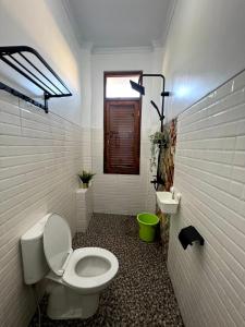 a bathroom with a toilet and a sink at Sabi House Danu, Family Home near Prawirotaman in Timuran +27 photos