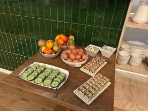 a table with bowls of fruits and vegetables on it at De Lola Podshotel in The Hague +24 photos