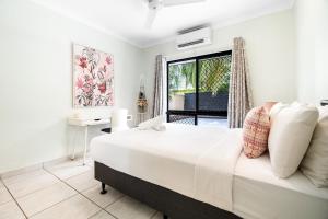 a white bedroom with a large bed and a window at Zen Orient Luxurious 4BR Oasis with Private Pool in Leanyer +33 photos