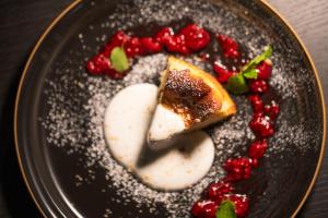 a black plate with a piece of food on it at TONES Osaka in Osaka