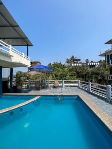 a pool at a resort with blue water at Casa Piedra Parada in Brisas de Zicatela