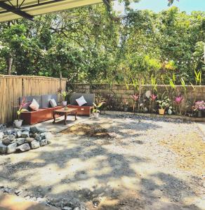 a patio with a couch and a table in a yard at Teena Verde in Puerto Princesa City