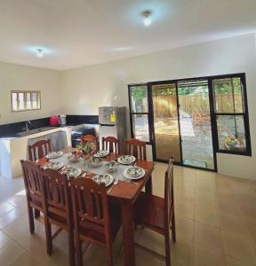 a dining room with a table and chairs in a kitchen at Teena Verde in Puerto Princesa City