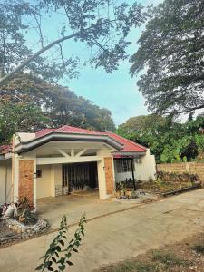 a small white building with a red roof at Teena Verde in Puerto Princesa City