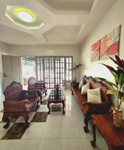 a living room with couches and a table at Teena Verde in Puerto Princesa City