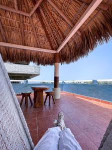 a person laying in a hammock on the beach at Casa Piedra Parada in Brisas de Zicatela