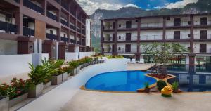 a hotel with a swimming pool in the middle of a courtyard at The Lai Thai Luxury Condominiums- Sha Extra Plus in Ao Nang Beach