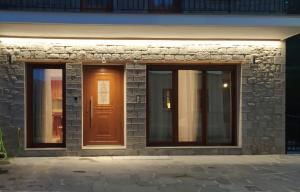 a front door of a building with a brown door at Metsovo apartment in Metsovo