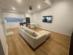 a living room with a white couch and a table at Silver Sands Villa in Mandurah