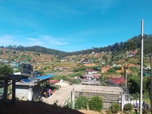 a view of a village on a hill at Oneli Homestay in Nuwara Eliya