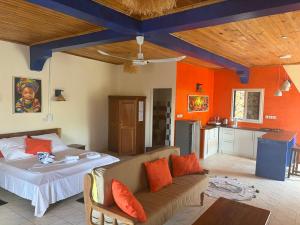 a living room with a couch and a kitchen at Villa Baby lodge in Hell-Ville +95 photos