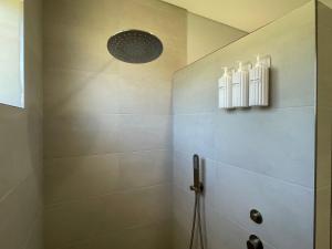 a bathroom with a shower with a shower head at Silver Sands Villa in Mandurah +12 photos