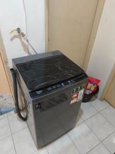 a stove top oven sitting in the corner of a kitchen at MonoStay Samarahan in Kota Samarahan