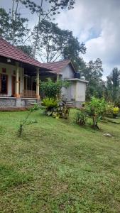 a house with a yard in front of it at Bali Home Taksu in Jatiluwih