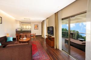 a living room with a couch and a dining room at Oakwood Residence Naylor Road Pune in Pune